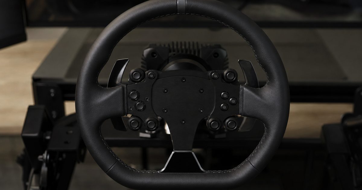 A round GT-style sim-racing steering wheel rim with leather grips, central buttons and paddle shifters, mounted to a direct-drive base.