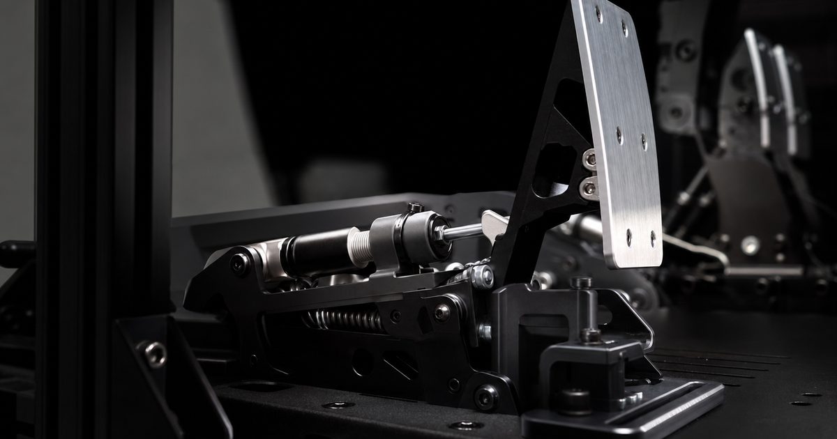 A load-cell sim racing pedal set mounted to a rig footplate.