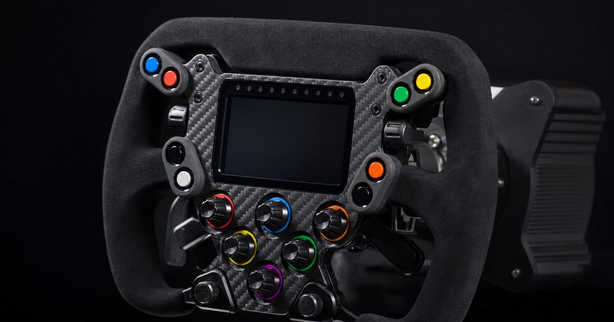 Close-up of a formula-style sim-racing steering wheel rim with a suede grip, coloured buttons, rotary dials and a central display.